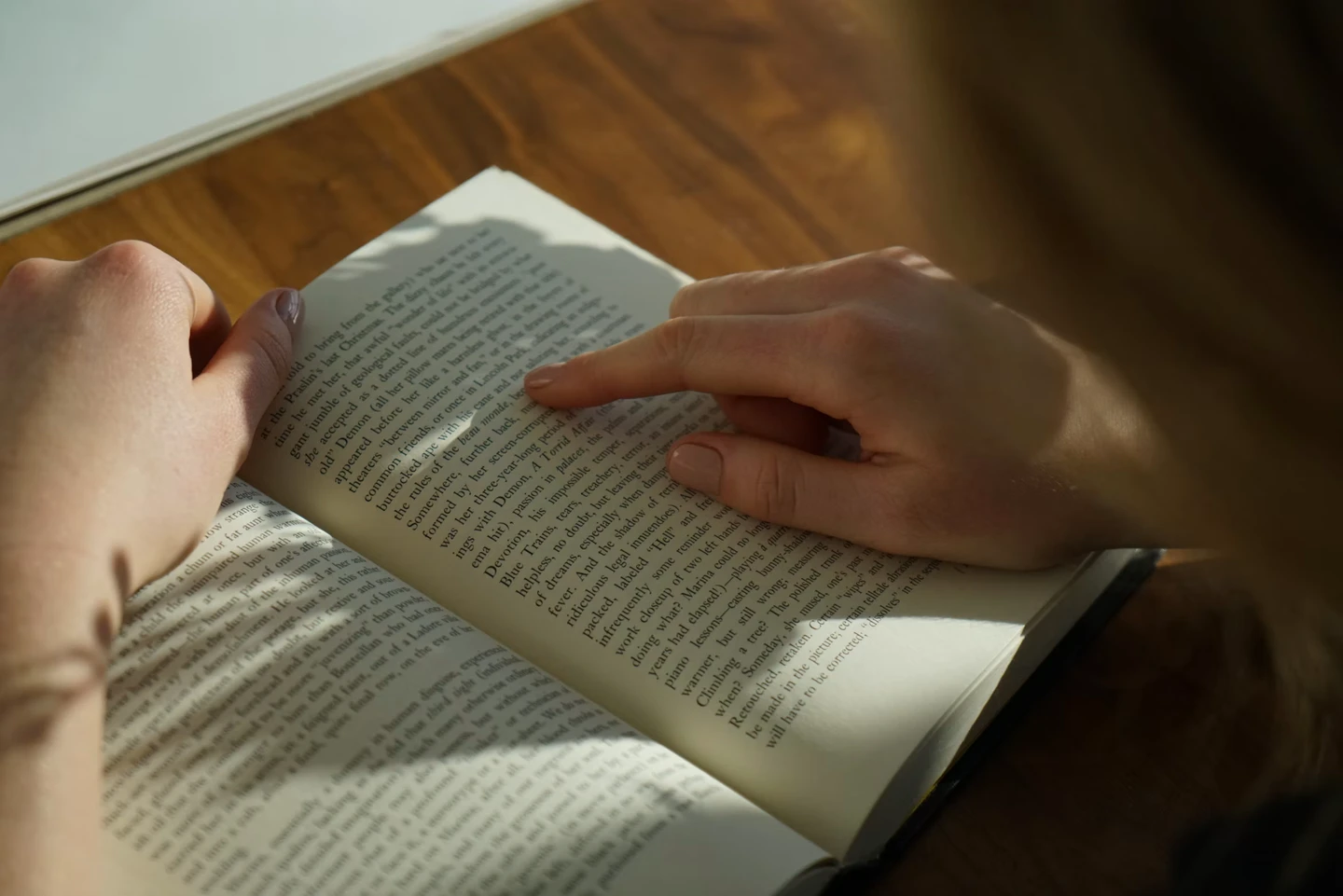 Person reading pages from a book