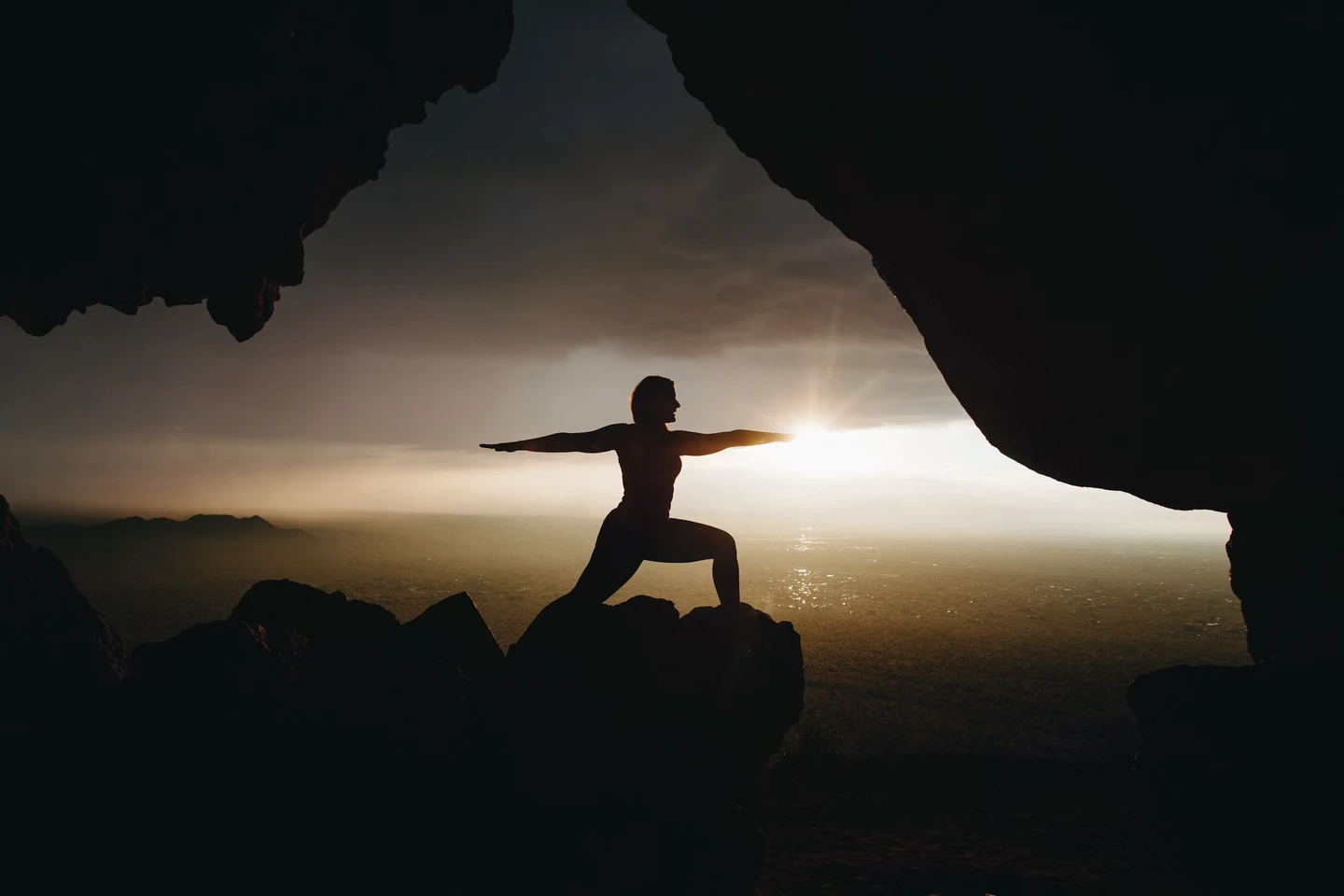 Person in yoga pose at sunset