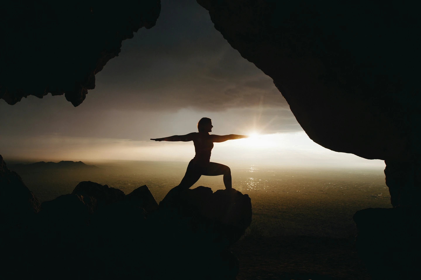 Person in yoga pose at sunset